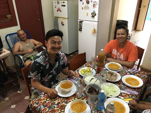 Image may contain: 3 people, including Nathan Yi, people smiling, people sitting, people eating and food